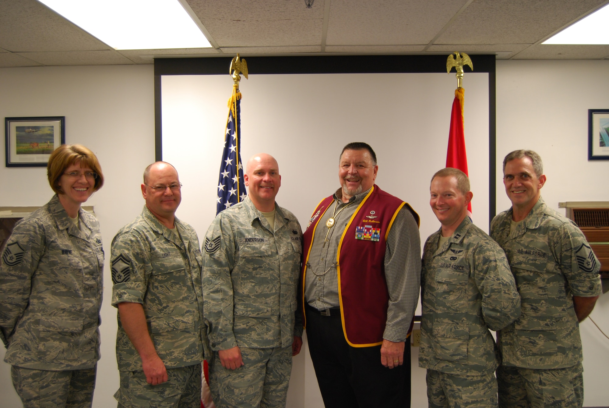 Retired USAF Capt. Bill Robinson poses with members of the 134 Logistics Squadron.  Capt. Robinson holds the distinction of being the longest held prisoner of war in United States history.  (Air National Guard photo by Staff Sgt. Mark Finney, 134 ARW Public Affairs)