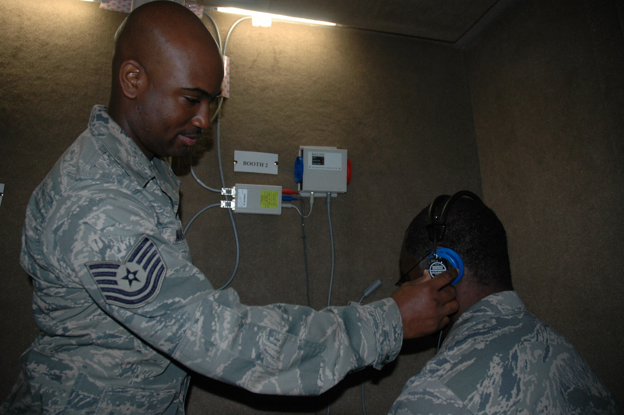 Technical Sergeant Damon Mazyck, noncommissioned officer in charge of 315th Aerospace Medicine Squadron Public Health, explains the process for taking an audiogram Saturday, May 1 at the clinic here at Charleston Air Force Base, S.C. (U.S. Air Force photo by Senior Airman Dani Shea / Released)