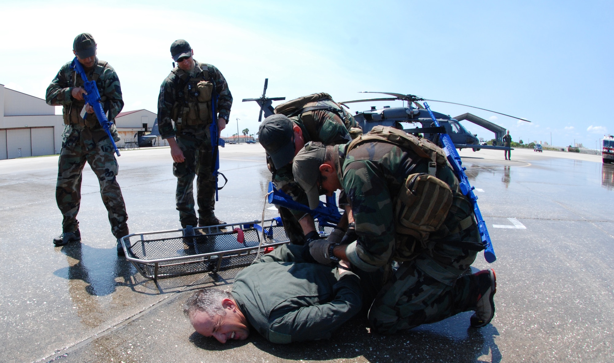 PATRICK AIR FORCE BASE, Fla. -  Colonel Steve "Wall Street" Kirkpatrick, Wing Commander of the 920th Rescue Wing, grimaces as he's zip-tied by pararescuemen after running from the HH-60G Pave Hawk helicopter at the conclusion of his FINI, or final, flight. Colonel Kirkpatrick has been commander of the 920th from April 2006 - May 2010.(U.S. Air Force photo/Staff Sgt. Leslie Kraushaar)
