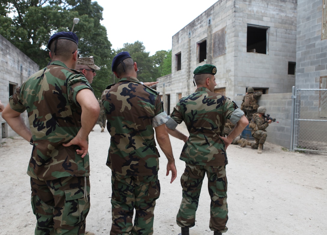 Officers with the Lebanese Armed Forces observe students with Company K, Marine Combat Training Battalion, execute basic combat skills at the Military Operations on Urban Terrain training center aboard Camp Devil Dog during an engagement visit to the United States, May 3.  Officials with Marine Corps Forces Central Command and LAF officers traveled to various Marine Corps training facilities along the East Coast, focusing on training plan development for the LAF and fostering international relationships.