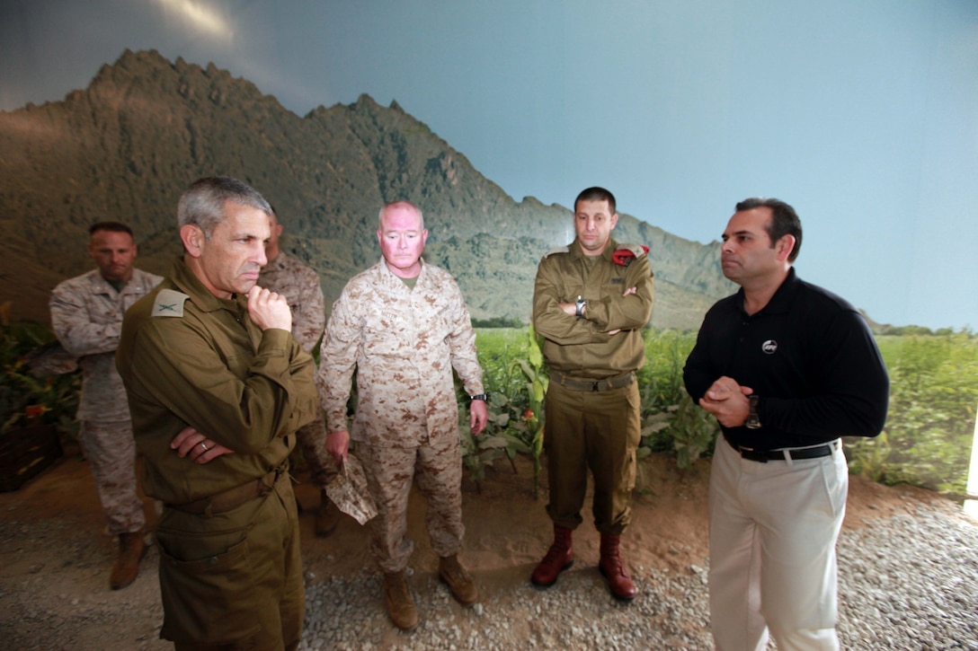 Brig. Gen. Mickey Edelstein (left), from Israel Defense Force, is shown the infantry immersion trainer by Maj. Gen. W. Lee Miller Jr. (center left), (acting) commanding general of 2nd Marine Division and Vince Soto (right), site leader for the Infantry Immersion Trainer aboard Marine Corps Base Camp Lejeune, N.C., March 13, 2012. The Infantry Immersion Trainer was established at Camp Lejeune in 2011 and is used to help prepare Marines for Afghanistan.