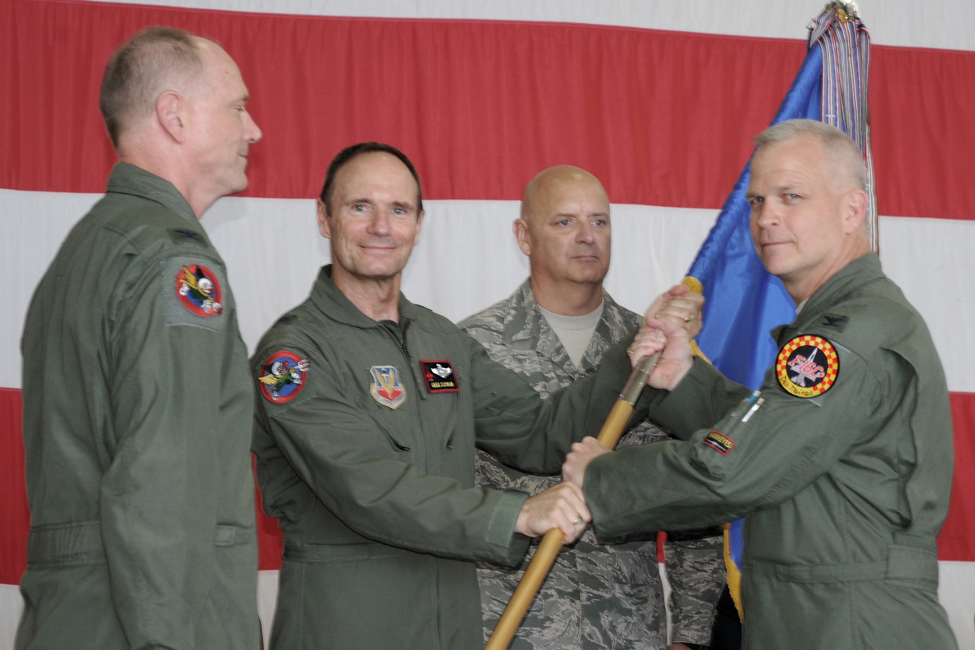 Colonel William Drew "Toto" DeHaes accepts the 132nd Fighter Wing guidon from Brig. Gen. Gregory Schwab, Assistant Adjutant General, Air Component, Iowa National Guard assuming command of the Wing during a Change of Command ceremony held in the west hanger at the Des Moines ANGB. Saturdays ceremony was the twelfth in the units almost 70 year history. (from left to right, Col. Mark "Eddie" Hammond, Brig. Gen. Gregory "Koa" Schwab, Chief Master Sgt. Lowell Schellhase Jr., Col. William Drew "Toto" DeHaes)(U.S. Air Force photo Senior Master Sgt. Tim Day)("Released") 