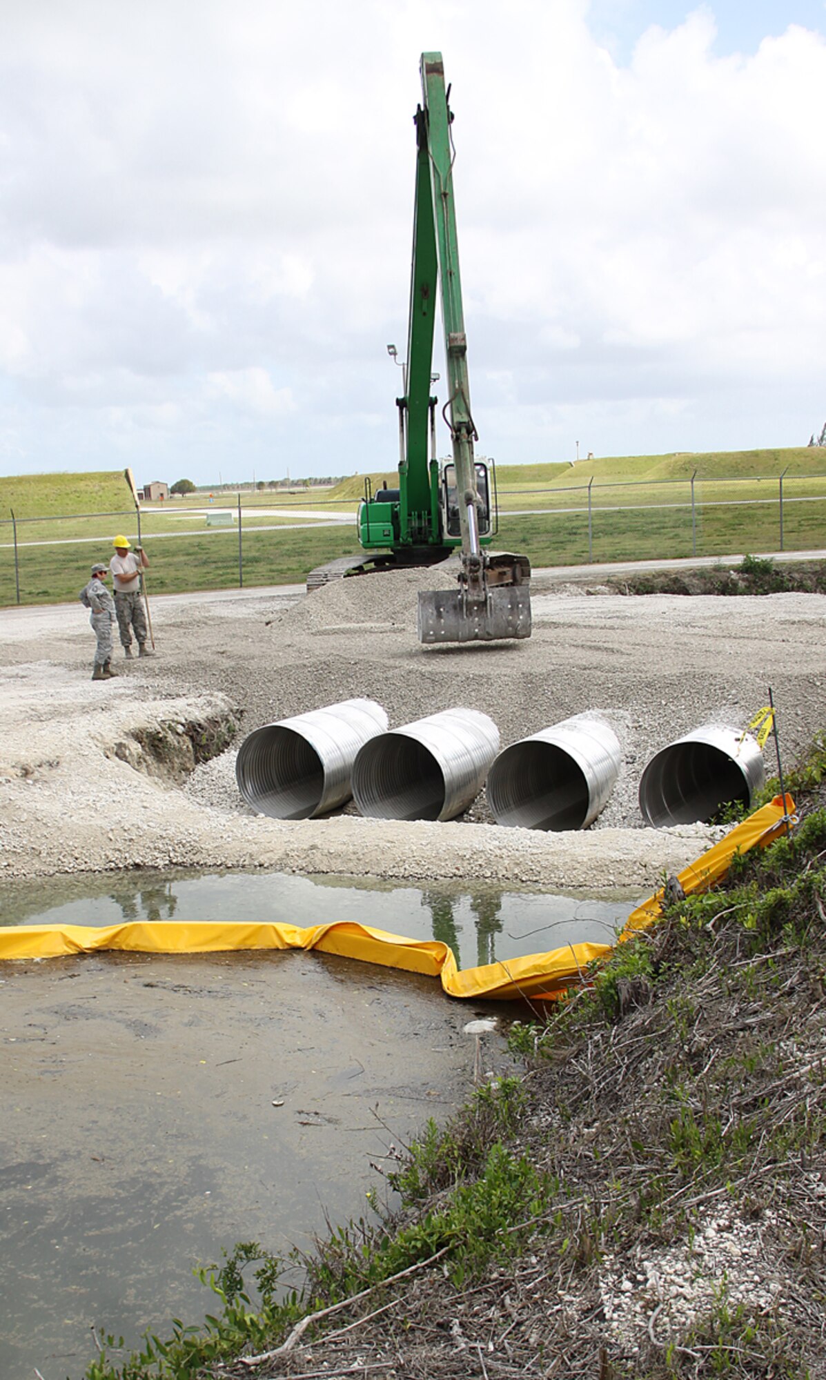 Crews from the 482nd Civil Engineering Squadron construct a new bridge at Homestead Air Reserve Base on April 15. The month long project has given the base a new emergency alternative route which will be a critical safety precaution for the 2010 Wings Over Homestead Air Show.  (U.S. Air Force photo/Senior Airman Lou Burton)
