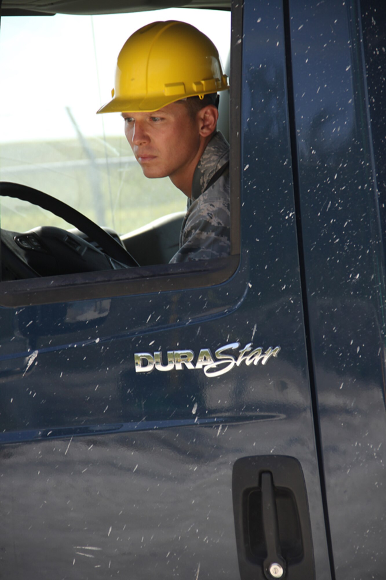 Senior Airman Andrew Lassman, 482nd Civil Engineering Squadron water and fuel systems apprentice, backs up a dump truck load of gravel to help build up the new bridge at Homestead Air Reserve Base on April 15. The month long project has given the base a new emergency alternative route on base, which will be a critical safety precaution for the 2010 Wings Over Homestead Air Show.  (U.S. Air Force photo/Senior Airman Lou Burton)