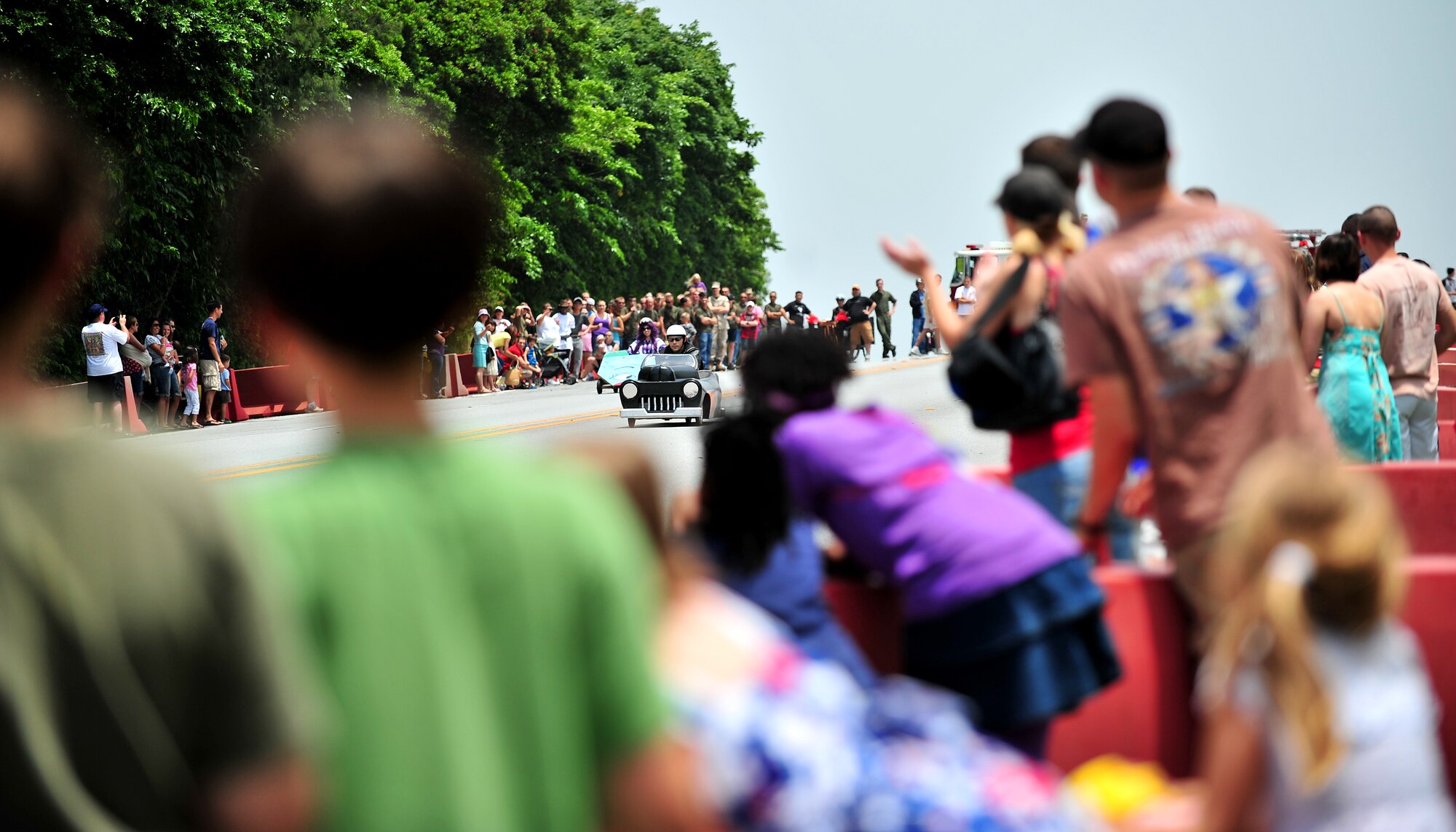 Soapbox derby racers descend Douglas Boulevard during the American Red Cross Derby Day May 1 at Kadena Air Base, Japan. The event raised $5,435 for the American Red Cross.  (U.S. Air Force photo/Tech. Sgt. Rey Ramon)   