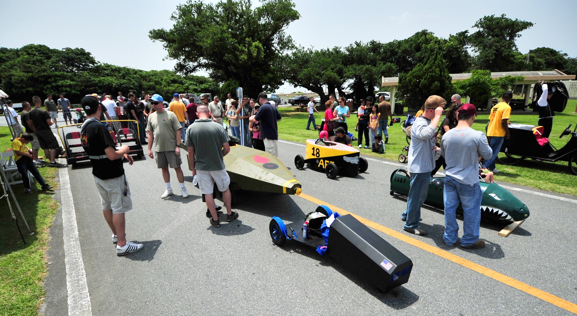 Kadena families enjoy the day looking at soapbox derby cars during the American Red Cross Derby Day May 1. The event raised $5,435 for the American Red Cross.  (U.S. Air Force photo/Tech. Sgt. Rey Ramon)
