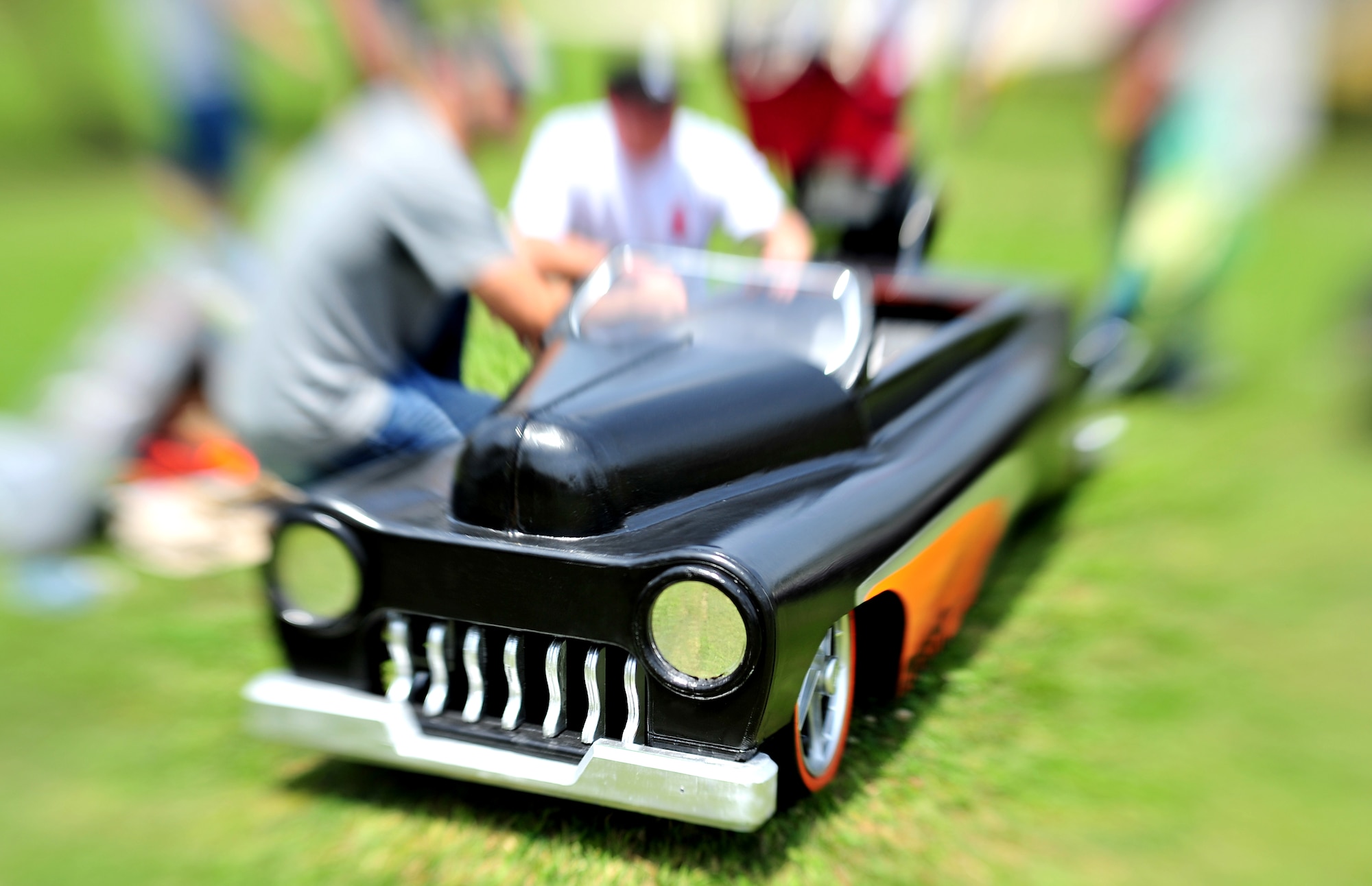 Kadena families enjoy the day looking at soapbox derby cars during the American Red Cross Derby Day May 1. The event raised $5,435 for the American Red Cross. The grease lightning derby car was built by Sgt. Matt Barger and Staff Sgt. Michael Moon, both from the 82nd Reconnaissance Squadron and placed first in the competition. (U.S. Air Force photo/Tech. Sgt. Rey Ramon)   