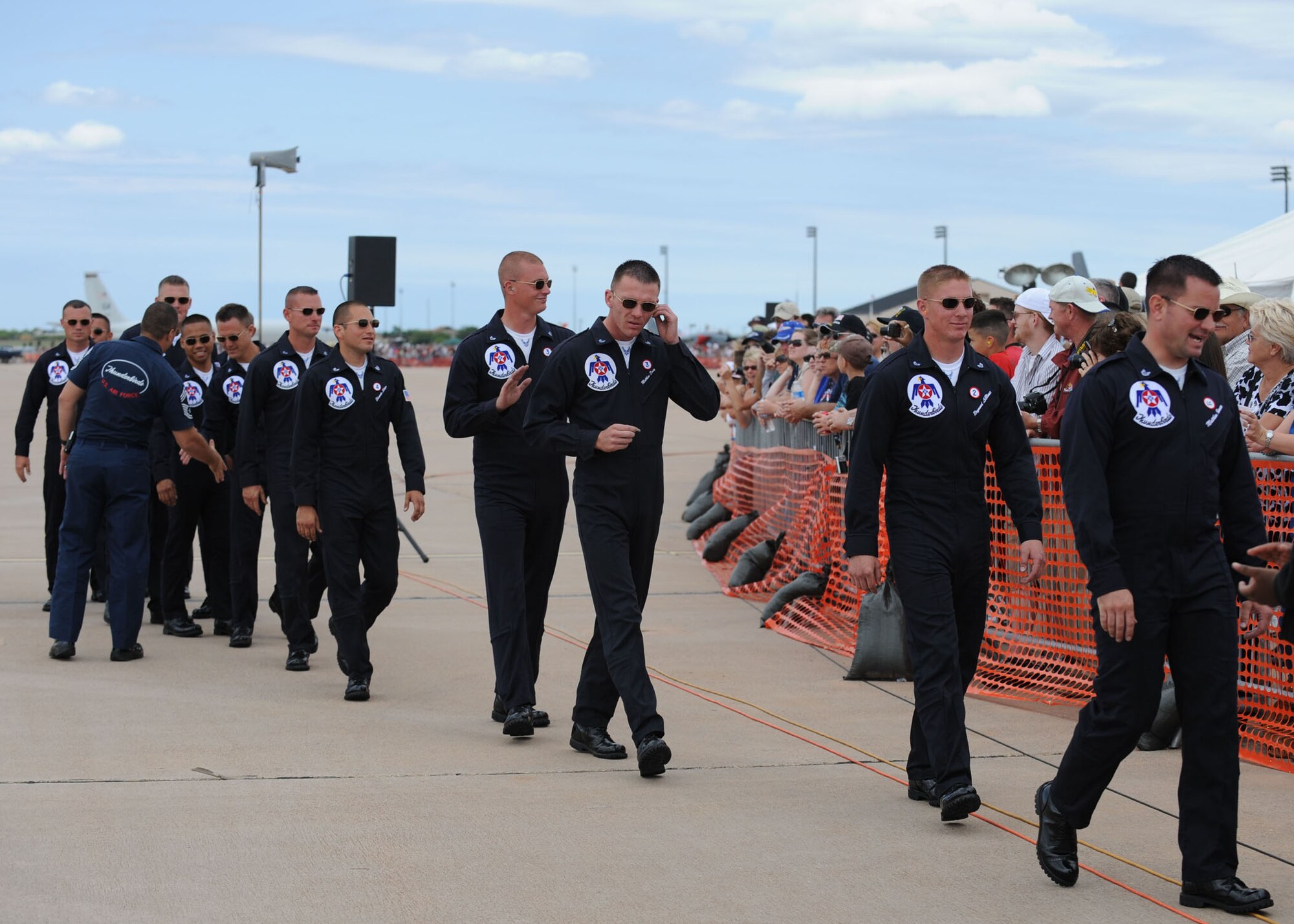 DYESS AIR FORCE BASE, Texas-- Members of the U.S Air Force Thunderbirds crew walk back to the crowd during the Dyess Big Country Airfest here May 1. The airfest is held every other year on Dyess Air Force Base and features various aircraft performances as well as static displays. The airfest is held to bring the Abilene and Dyess communities together to demonstrate the capabilities of the Air Force.(U.S Air Force photo/ Airman 1st Class Shannon Hall)