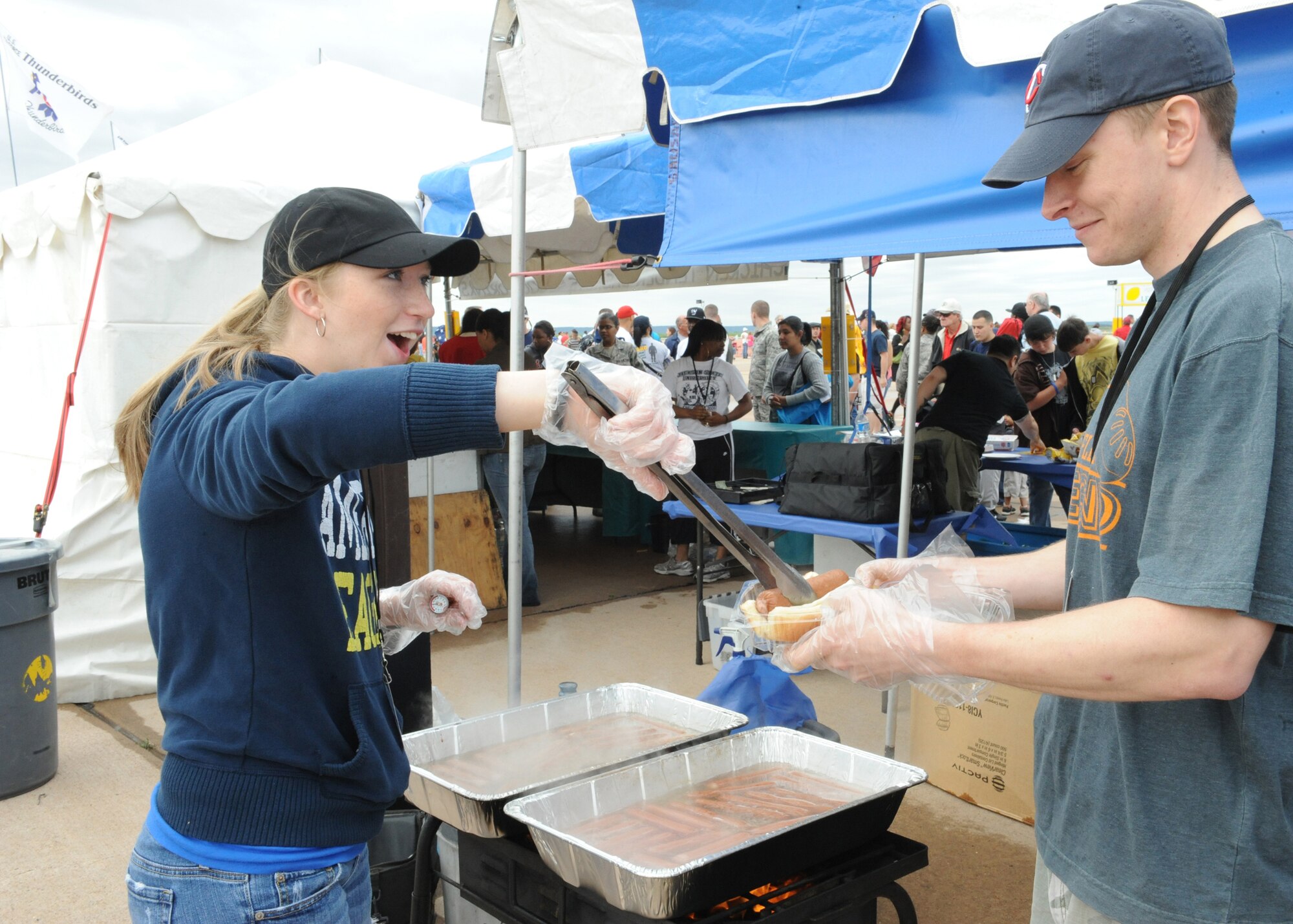 DYESS AIR FORCE BASE, Texas-- Airman 1st Class Hannah Wade and 2nd Lt. Bradley Radtke, both from the 7th Comptroller Squadron, prepare and sell hotdogs at the Dyess Big Country AirFest here May 1.  The airfest is held every other year on Dyess Air Force Base and features various aircraft performance as well as static displays. The airfest is held to bring the Abilene and Dyess communities together to demonstrate the capabilities of the Air Force.  (U.S Air Force photo/ Airman 1st Class Shannon Hall)
