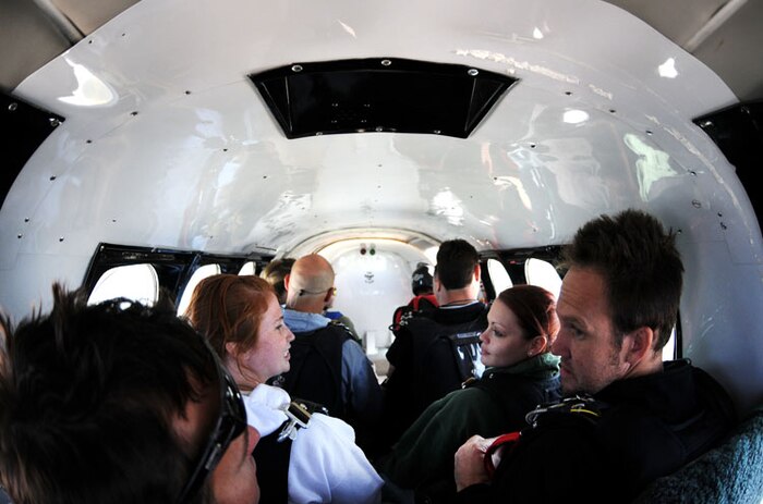 Airmen wait nervously, strapped to their skydiving instructors, as the plane they are about to leap out of rises to 14,000 feet, April 30 above Lincoln Regional Airport. The Airmen were part of Beale’s “Jump into Prevention” event to raise sexual assault awareness. (Air Force photo by Airman 1st Class David Tracy)