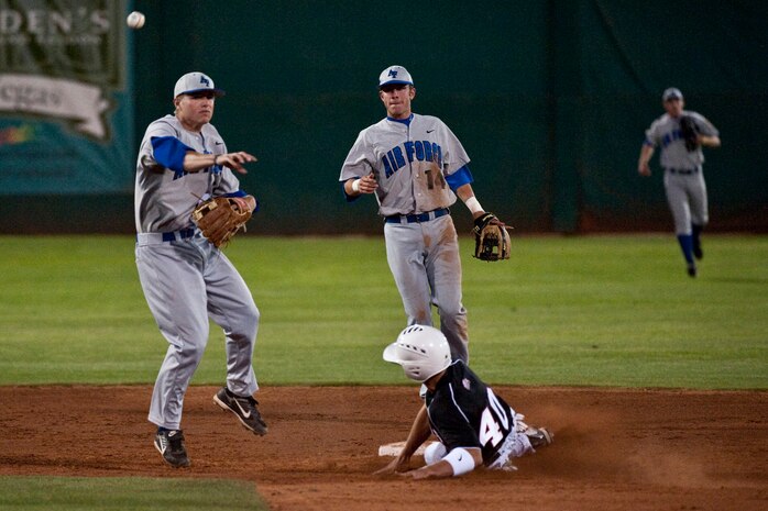 LAS VEGAS --   Adam Hill a sophomore infielder from the U.S. Air Force Academy "Falcons" turns a double play during a late afternoon game against the University of Nevada, Las Vegas "Rebels,"  at Earl E. Wilson Stadium, in Las Vegas April 30, 2010. UNLV declared the weekend, Air Force weekend and offered free admission for all active duty during the Air Force Academy vs. UNLV baseball games.  (U.S. Air Force photo by Tech. Sgt. Michael R. Holzworth)