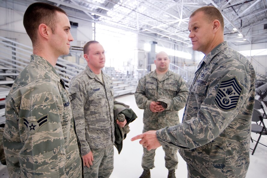 Chief Master Sgt of the Air Force James A. Roy, right, encourages Airman 1st Class Kevin Husbands, 62nd Aircraft Maintenance Squadron, while meeting with a group of McChord Field maintainers following an enlisted call in Hangar 9 April 28. (U.S. Air Force Photo/Abner Guzman)