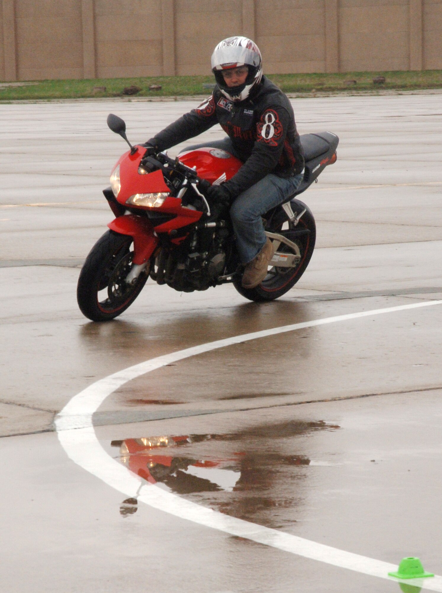 Staff Sergeant Stephen Ondrovich, 337th Training Squadron, heads into a right turn on the sport bike safety training course April 30 at Grand Forks Air Force Base, N.D. The safety training course is part of the Air Mobility Command Sport Bike Course, which is a requirement for all military (on and off the installation) and Department of Defense civilians (while on the installation) to operate a sport bike while assigned to an AMC unit. The training is an all day event and once certified the operator will remain certified for as long as they are assigned to an AMC unit or unless otherwise directed. (U.S. Air Force photo by Airman 1st Class Rachel Martinez)