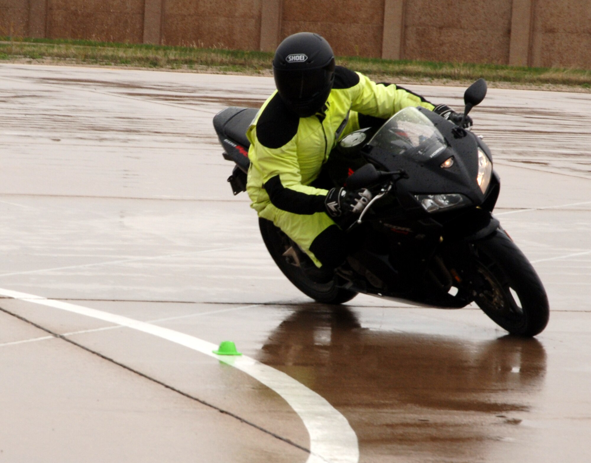 Capt. Ryan Peterson, 905th Air Refueling Squadron and instructor for the Air Mobility Command Sport Bike Course, demonstrates a portion of the training course April 30 at Grand Forks Air Force Base, N.D. The AMC Sport Bike Course is a requirement for all military (on and off the installation) and Department of Defense civilians (while on the installation) to operate a sport bike while assigned to an AMC unit. The training is an all day event and once certified the operator will remain certified for as long as they are assigned to an AMC unit or unless otherwise directed. (U.S. Air Force photo by Airman 1st Class Rachel Martinez)