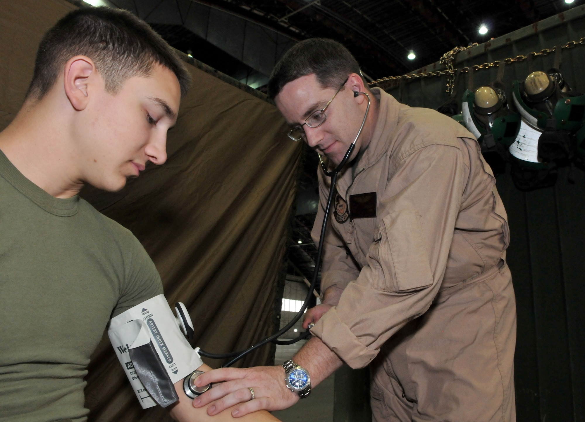 Navy Lt. Kevin Winegar, VMA-211 flight surgeon, Marine Corps Air Station, Yuma, Ariz., performs a physical exam on Marine Lance Cpl. Jacob Ellis, an avionics technician on AV-8B Harriers, during Red Flag-Alaska at Eielson Air Force Base, Alaska April 26. Corporal Ellis is deployed with the VMA-211. Red Flag-Alaska is a 10-day field training exercise that provides joint offensive counter-air, interdiction, close air support and large force employment training in a simulated combat environment. (U.S. Air Force photo/Capt. Shannon Collins)