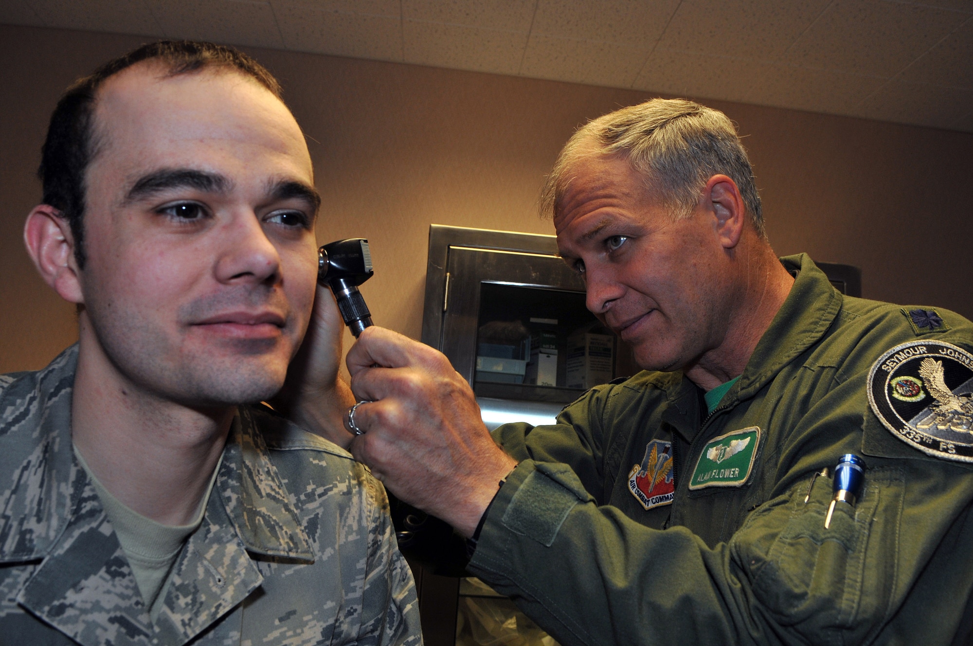 Lt. Col. (Dr.) Alan Flowers, Seymour Johnson Air Force Base, N.C., performs a physical on Senior Airman Carl Hanck, a range quality assurance practioner with the 353rd Combat Training Squadron, Eielson Air Force Base, Alaska, who received an incentive flight on a B-52 Stratorfortress during Red Flag-Alaska. Red Flag-Alaska is a 10-day field training exercise that provides joint offensive counter-air, interdiction, close air support and large force employment training in a simulated combat environment. (U.S. Air Force photo/Capt. Shannon Collins)