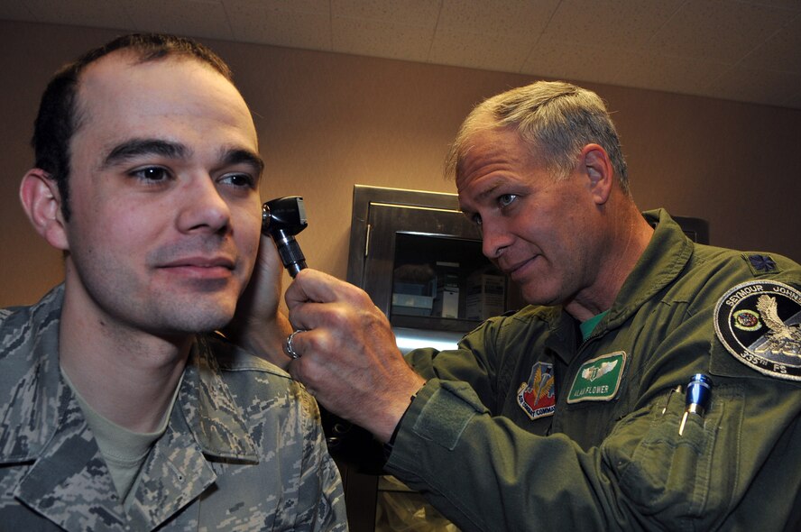 Lt. Col. (Dr.) Alan Flowers, Seymour Johnson Air Force Base, N.C., performs a physical on Senior Airman Carl Hanck, a range quality assurance practioner with the 353rd Combat Training Squadron, Eielson Air Force Base, Alaska, who received an incentive flight on a B-52 Stratorfortress during Red Flag-Alaska. Red Flag-Alaska is a 10-day field training exercise that provides joint offensive counter-air, interdiction, close air support and large force employment training in a simulated combat environment. (U.S. Air Force photo/Capt. Shannon Collins)