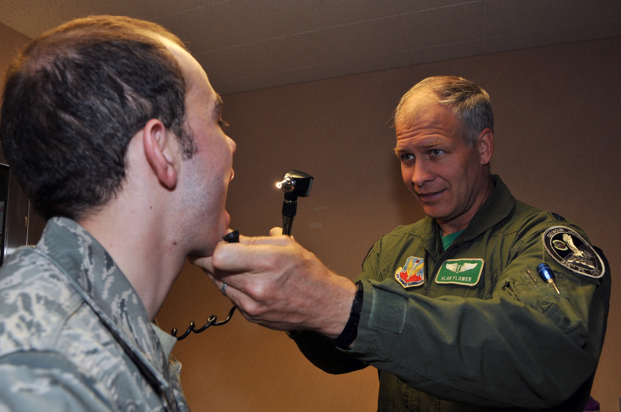 Lt. Col. (Dr.) Alan Flowers, Seymour Johnson Air Force Base, N.C., performs a physical on Senior Airman Carl Hanck, a range quality assurance practioner with the 353rd Combat Training Squadron, Eielson Air Force Base, Alaska, who received an incentive flight on a B-52 Stratorfortress during Red Flag-Alaska April 22. Red Flag-Alaska is a 10-day field training exercise that provides joint offensive counter-air, interdiction, close air support and large force employment training in a simulated combat environment. (U.S. Air Force photo/Capt. Shannon Collins)