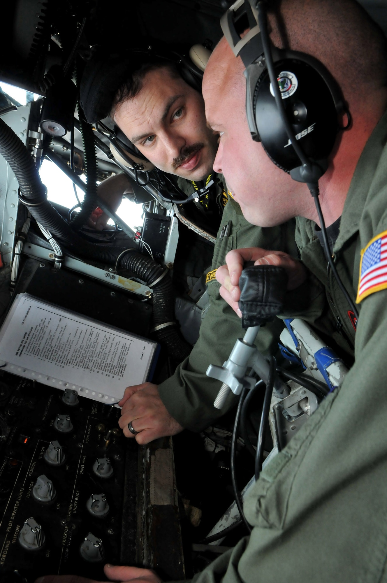 Capt. (Dr.) Tom Beachkofsky, 80th Fighter Squadron flight doctor, listens as Tech. Sgt. Gabe Ourso, 92nd Air Refueling Squadron, Fairchild Air Force Base, Wash., boom operator, explains his role in the joint mission during Red Flag-Alaska April 21. Red Flag-Alaska is a 10-day field training exercise that provides joint offensive, counter-air, interdiction, close air support and large force employment training in a simulated combat environment. (U.S. Air Force photo/Capt. Shannon Collins)