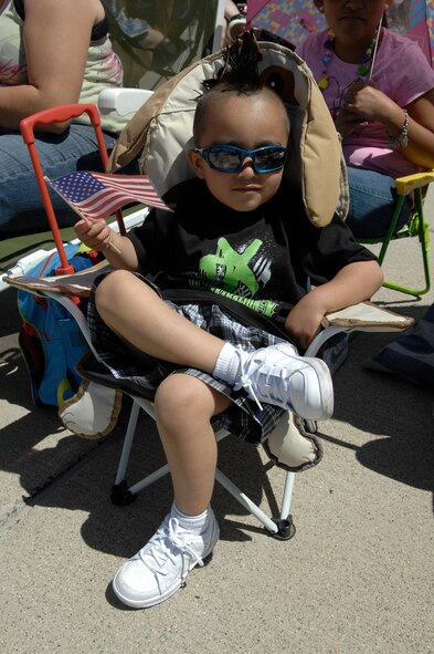 A child enjoys the sunny weather during March Field AirFest, March Air Reserve Base, Calif., May 1, 2010. March Field AirFest is a two-day event featuring performances and static displays of civilian and military aircraft. (U.S.  Air Force photo by Senior Airman Matthew Smith/Released)