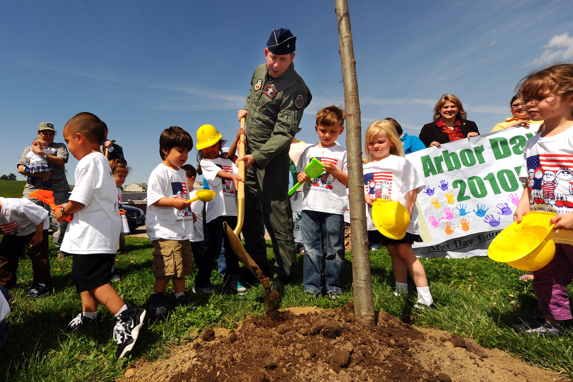 OFFUTT AIR FORCE BASE, Neb. -- Brig. Gen. John N.T. Shanahan, 55th Wing commander, shovels dirt around a newly planted Northern Redwood Oak tree with the help of the children of Child Development Center II here April 29 in celebration of Arbor Day. Offutt has been named Tree City USA for the last 22 years by the Arbor Day Foundation. U.S. Air Force photo by Josh Plueger