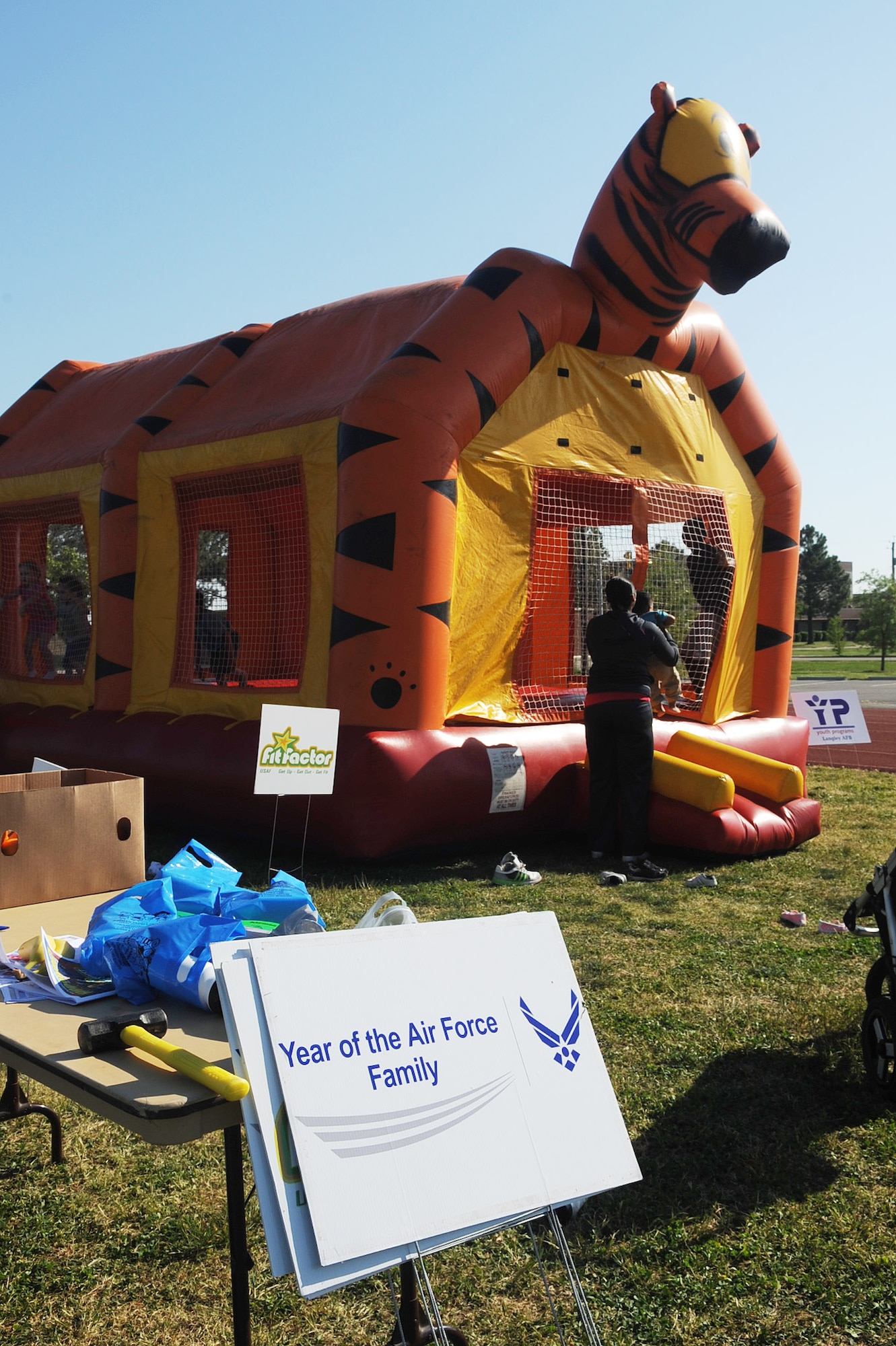 LANGLEY AIR FORCE BASE, Va. -- Signs sit posted near the bouncy castle during the May fitness month kick-off, at the shellbank Fitness center, May. The month of May is designated annually as fitness month, which is in conjunction with The Year of the Air Force Family this year, encouraging Airmen and their families to get active together and live healthier lives. (U.S. Air Force photo/Staff Sgt. Ashley Hawkins) 