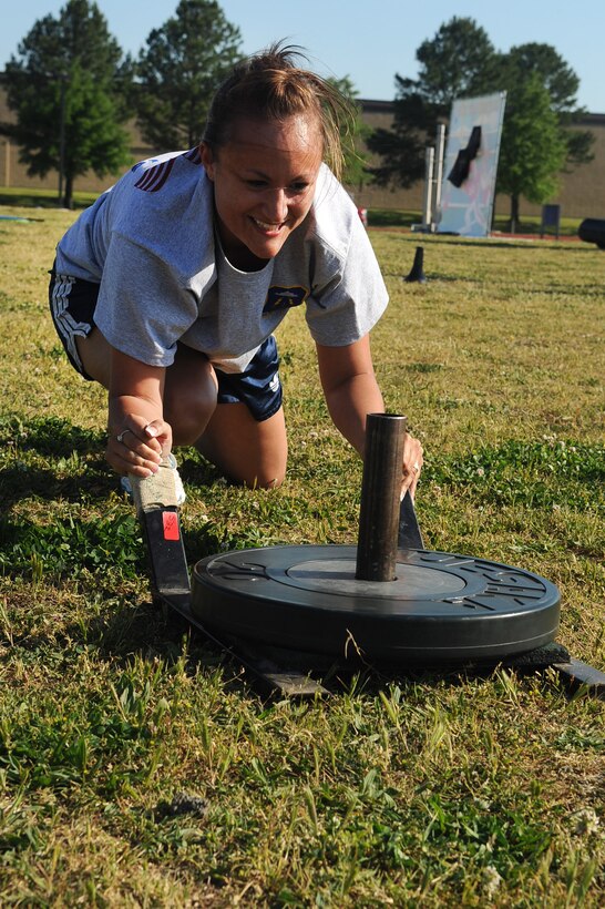 LANGLEY AIR FORCE BASE, Va. -- Staff Sgt Cristina Sullivan, 633d Force Support Squadron fitness center specialist pushes weights to the goal during the May fitness month extravaganza obstacle course, at the shellbank fitness center track May 1. The month long celebration of fitness, held annually, is combined this year with The Year of the Air Force Family, promoting awareness of  different activities families can perform together outside of the fitness center. (U.S. Air Force photo/Staff Sgt. Ashley Hawkins) 