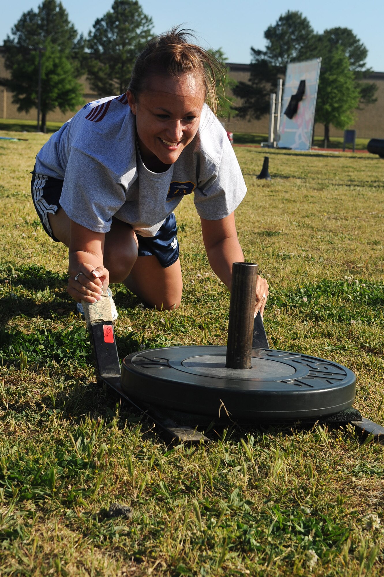 LANGLEY AIR FORCE BASE, Va. -- Staff Sgt Cristina Sullivan, 633d Force Support Squadron fitness center specialist pushes weights to the goal during the May fitness month extravaganza obstacle course, at the shellbank fitness center track May 1. The month long celebration of fitness, held annually, is combined this year with The Year of the Air Force Family, promoting awareness of  different activities families can perform together outside of the fitness center. (U.S. Air Force photo/Staff Sgt. Ashley Hawkins) 