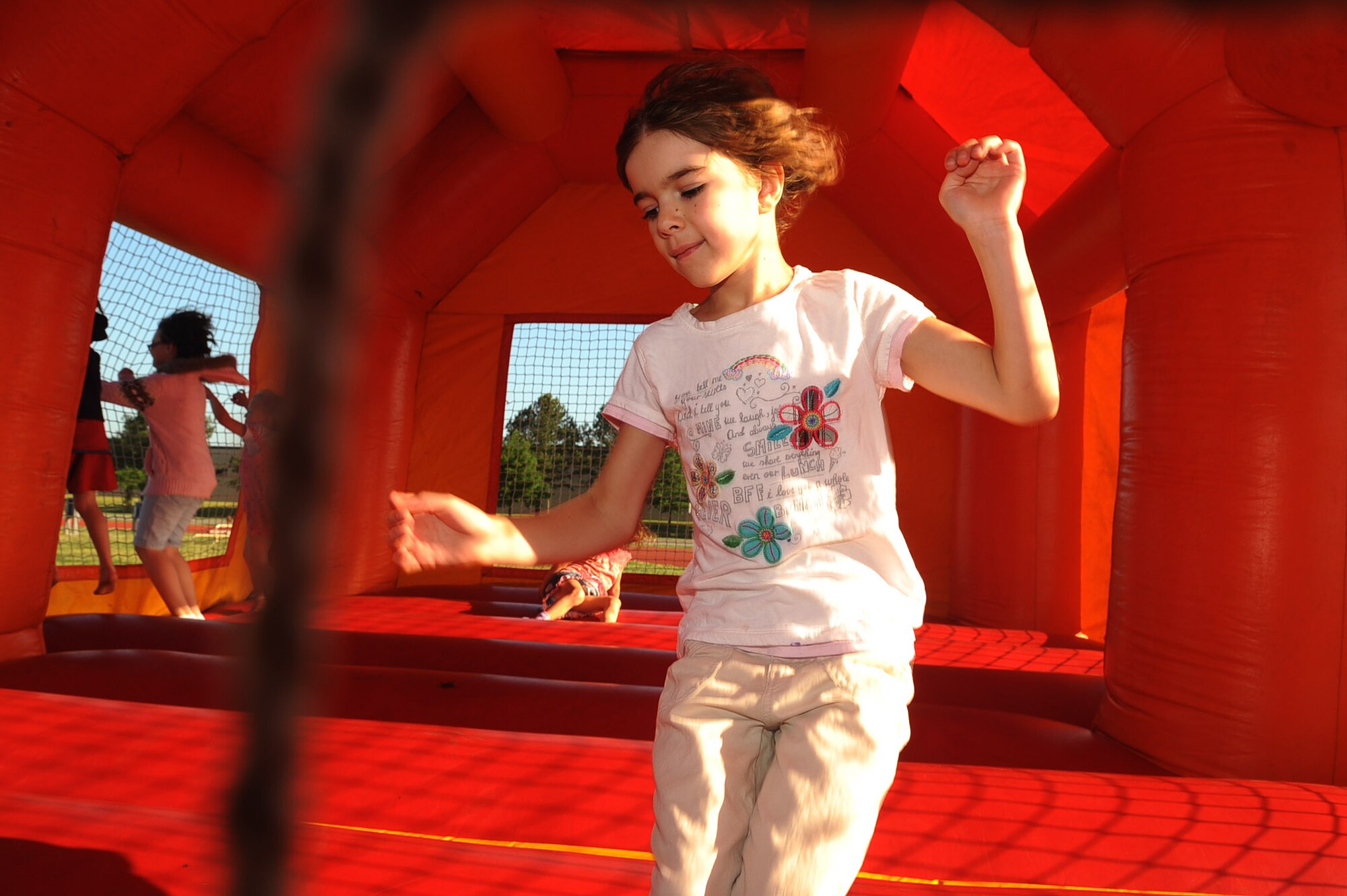 LANGLEY AIR FORCE BASE, Va -- Katelyn Basak, 7-year-old daughter of Lt. Col. Richard Basak, Air Combat Command director of operations, and Maj. Jennifer Basak, 610th AMDF, jumps around in the bouncy castle during the May Fitness Month Kick-off Extravaganza at the shellbank fitness center May 1. May fitness month is held annually to promote exercising and to encourage personnel and their families to lead healthier lifestyles. (U.S. Air Force photo/Staff Sgt. Ashley Hawkins) 