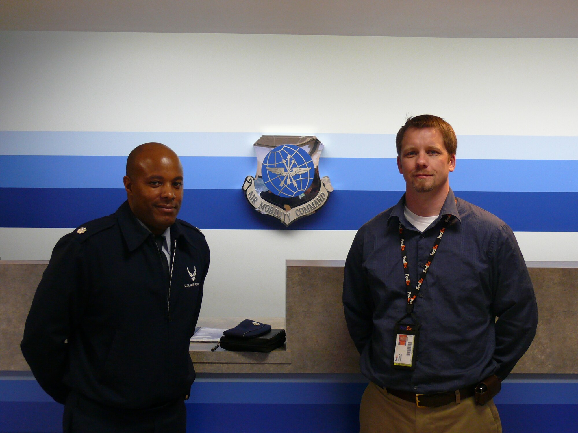 Lt. Col. Will Phillips, 62nd Aerial Port Squadron commander (left) and Tom Embleton, 62nd APS honorary commander, pose for a photo during Mr. Embleton's tour of the squadron April 26.  Mr. Embleton works for FedEx, and noted the similarities between the organizations.  (U.S. Air Force photo/A1C Joshua F. Pelto)


