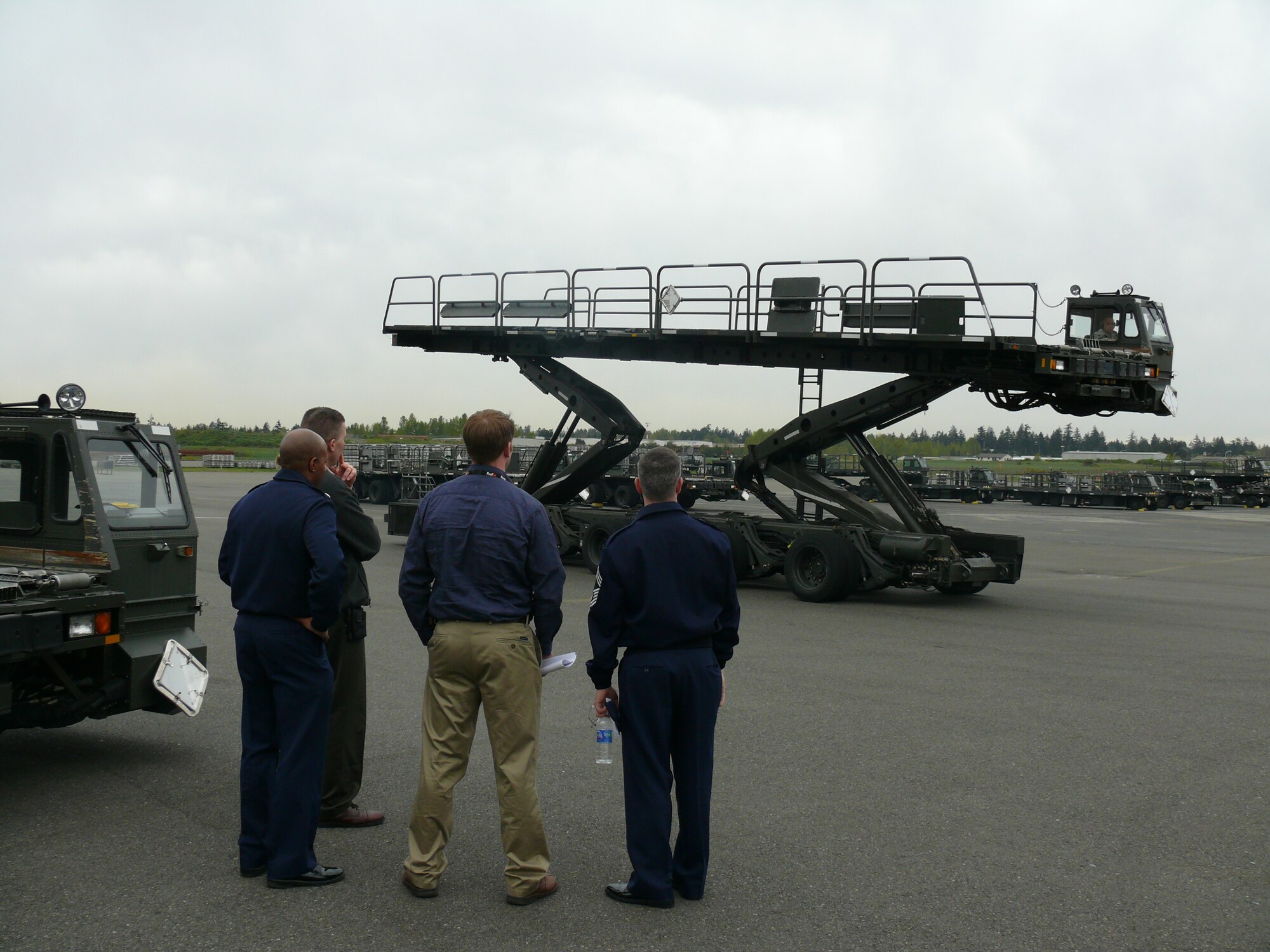 Staff Sgt. Alejandro Castillo, 62nd Aerial Port Squadron, demonstrates the range of capabilities of a Halvorsen 25K Loader for the 62nd APS Honorary Commander's tour of the squadron April 26. (U.S. Air Force photo/A1C Joshua F. Pelto)
