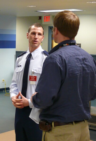 Capt. Jeremy Denman, 62nd Passenger Services Flight Commander, briefs the 62nd Aerial Port Squadron honorary commander, Mr. Tom Embleton from FedEx, regarding the operations of the passenger terminal that serves thousands of customers each year.  (U.S. Air Force photo/A1C Joshua F. Pelto)


