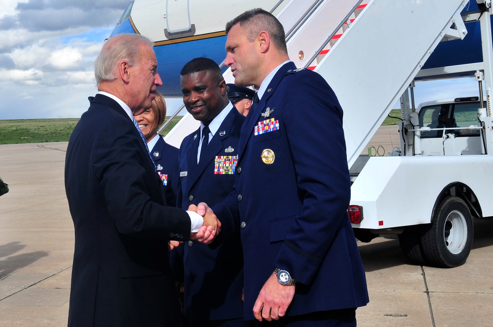 BUCKLEY AIR FORCE BASE, Colo. -- Vice President Joe Biden is greeted by Col. Trent Pickering, 460th Space Wing vice commander, Chief Master Sgt. Gregory Williams, acting 460th SW command chief, and Master Sgt. DeRinda Johnson, 460th SW staff first sergeant, April 30. (U.S. Air Force Photo By Airman 1st Class Manisha Vasquez)