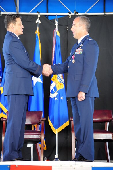 PATRICK AIR FORCE BASE, Fla. -- Maj. Gen. Frank J. Padilla, 10th Air Force Commander, congratulates Colonel Steven W. Kirkpatrick after presenting the colonel with the Legion of Merit May 2 at the 920th Rescue Wing Change of Command Ceremony here. General Padilla commented on the careers and accomplishments of Colonel Kirkpatrick, the outgoing Wing Commander, and Colonel Robert L. Dunn, the incoming Wing Commander during the general's remarks, thanking them both for their service. Colonel Dunn was previously the Commander of the 943rd Rescue Group at Davis-Monthan AFB, Ariz., one of the 920th Geographically Separated Units (GSU.) Colonel Kirkpatrick now begins his new job as the senior Air Force Reserve Adviser to the Commander of U.S. Special Operations Command at MacDill AFB, Fla. (U.S. Air Force photo/Master Sgt. Rob Grande)
