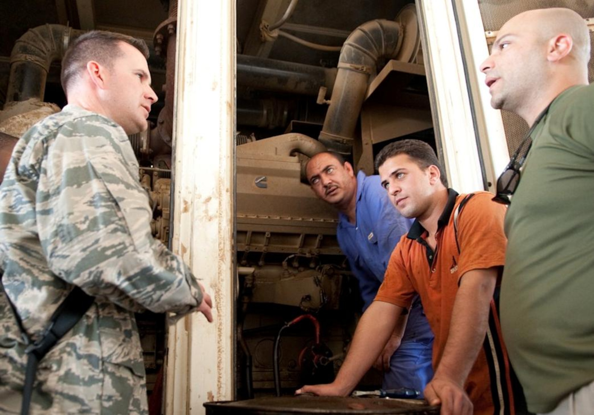 Tech. Sgt. Vincent Dilore explains some of the finer points of preventative maintenance to two Iraqi Army power production technicians April 20, 2010, during a visit to Camp Ur, Iraq, as part of an Iraqi Training and Advisory Mission. Sergeant Dilore is assigned to the 407th Air Expeditionary Group Civil Engineer Squadron power production flight. (U.S. Air Force photo/Senior Master Sgt. Elizabeth Gilbert)
