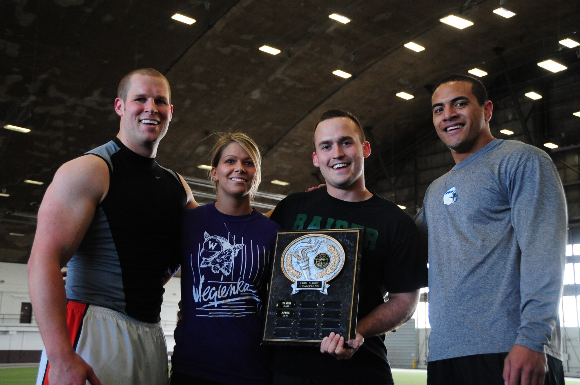 ELLSWORTH AIR FORCE BASE, S.D. – (Right to left) 2nd Lt. Richie Amisone, 28th Comptroller Contracting Squadron financial services officer, Airman 1st Class James Randolph, 28 CCS contract administrator, his wife, Alesia Randolph and 2nd Lt. Austin Dowling, 28 CCS financial analyst, hold the Iron Flight competition trophy, April 29.  Winning this quarter’s competition makes two wins in a row for this team. (U.S. Air Force photo/Airman 1st Class Anthony Sanchelli)