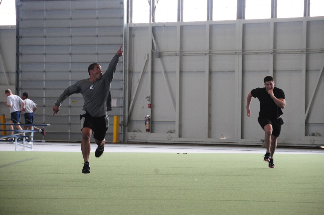 ELLSWORTH AIR FORCE BASE, S.D. – (Left to right) 2nd Lt. Richie Amisone, 28th Comptroller Contracting Squadron financial service officer, holds up his hand for “number one” while racing Senior Airman Zachary Yoakam, 28th Operations Group survival, evasion, resistance and escape specialist, during the Iron Flight competition, April 29.  The competition is scheduled by the 28th Force Support Squadron every quarter. (U.S. Air Force photo/Airman 1st Class Anthony Sanchelli)