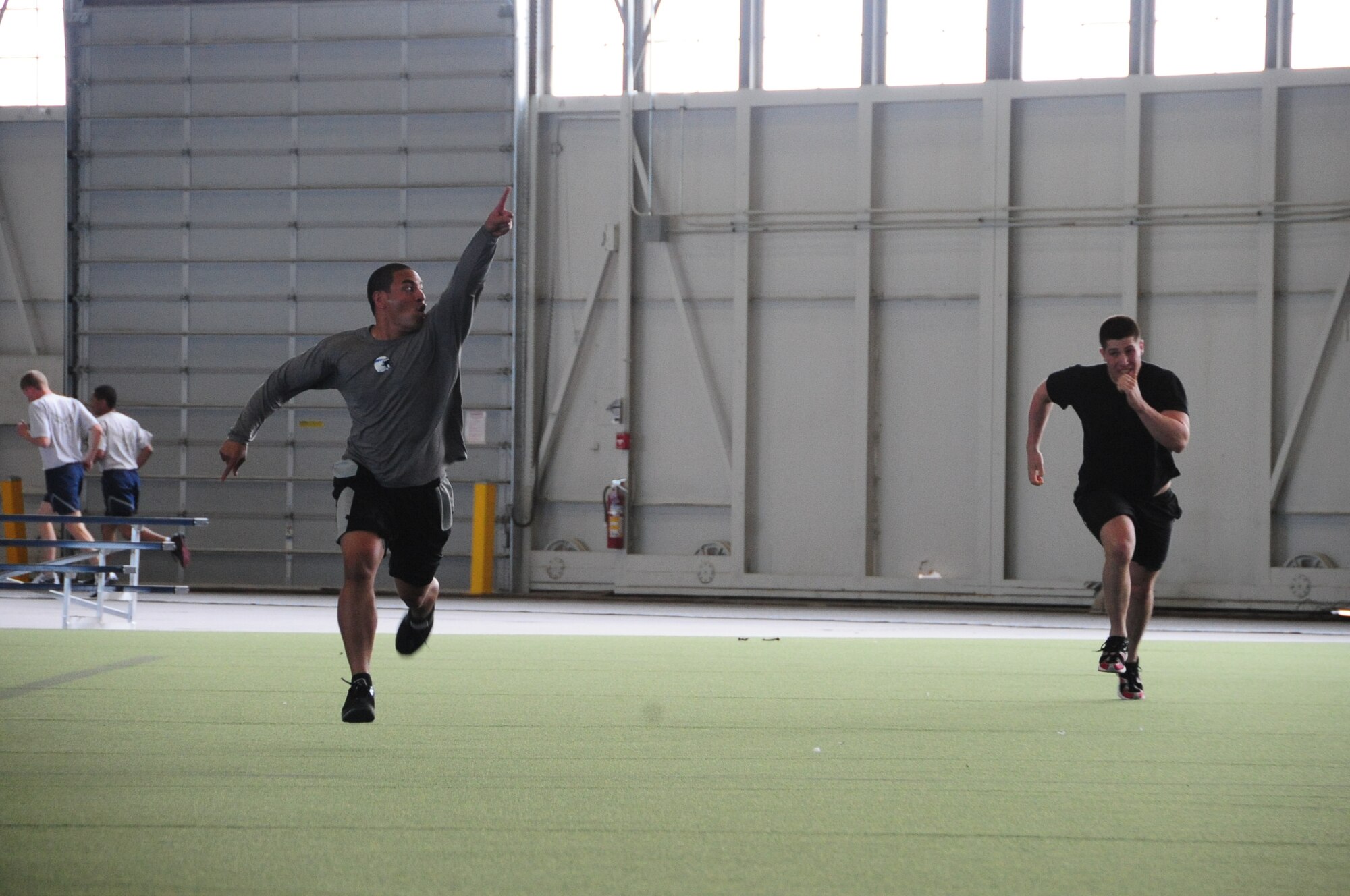 ELLSWORTH AIR FORCE BASE, S.D. – (Left to right) 2nd Lt. Richie Amisone, 28th Comptroller Contracting Squadron financial service officer, holds up his hand for “number one” while racing Senior Airman Zachary Yoakam, 28th Operations Group survival, evasion, resistance and escape specialist, during the Iron Flight competition, April 29.  The competition is scheduled by the 28th Force Support Squadron every quarter. (U.S. Air Force photo/Airman 1st Class Anthony Sanchelli)