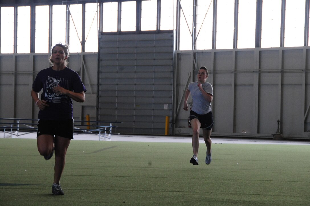 ELLSWORTH AIR FORCE BASE, S.D. -- (Left to right) Alesia Randolph, wife of Airman 1st Class James Randolph, 28th Comptroller Contracting Squadron contract administrator, races Airman 1st Class Alison Meyer, 28th Operations Group intelligence analyst, during the Iron Flight competition, April 29.  Mrs. Randolph’s team took first place in the quarterly competition. (U.S. Air Force photo/Airman 1st Class Anthony Sanchelli)