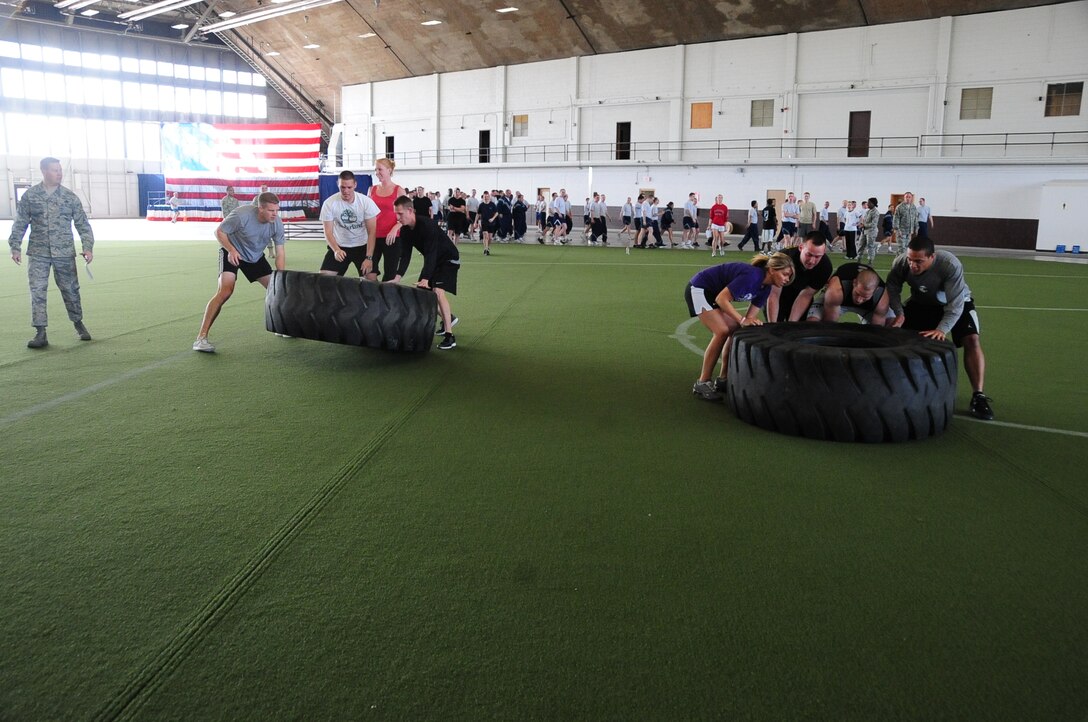 ELLSWORTH AIR FORCE BASE, S.D. – Two teams compete against each other in a tire-flip event during the iron flight competition, April 29.  A total of four teams competed through several events for the quarterly Iron Flight trophy. (U.S. Air Force photo/Airman 1st Class Anthony Sanchelli)