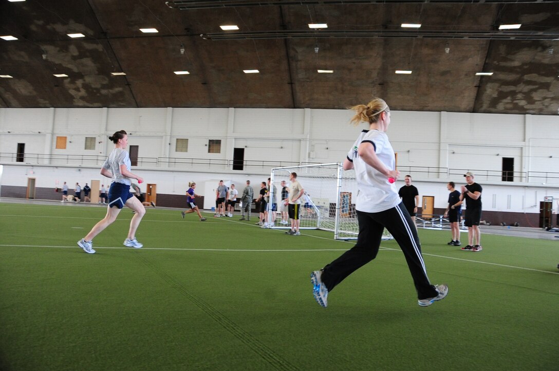 ELLSWORTH AIR FORCE BASE, S.D. – (Left to right) Airman 1st Class Alison Meyer, 28th Operations Group intelligence analyst and Tech. Sgt. Betty Navarro, 28th Communications Squadron application services NCO in-charge, race across a field during the Iron Flight competition, April 29.  The competition consisted of four teams that endured several different events as well as a tie breaker event for the top two teams. (U.S. Air Force photo/Airman 1st Class Anthony Sanchelli)