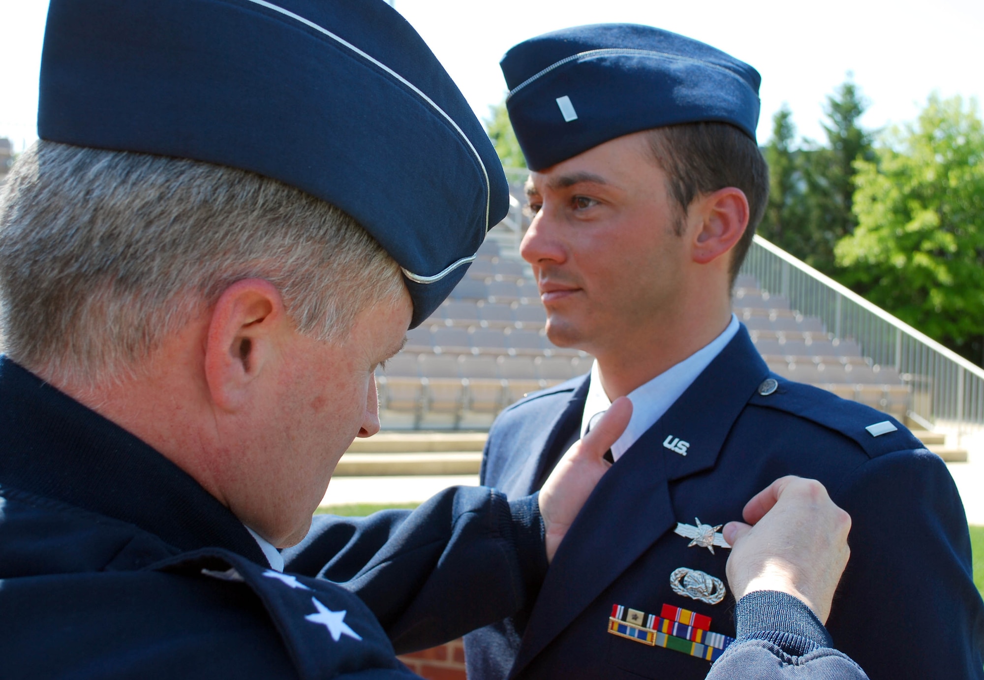 Lt. Gen. William T. Lord, chief of warfighting integration and chief information officer in the Office of the Secretary of the Air Force, pins the new cyberspace badge on 1st Lt. Thomas P. McGrevey April 30, 2010.  Lieutenant McGrevey is assigned to the 844th Communications Group at Bolling Air Force Base, D.C. (U.S. Air Force photo/Master Sgt. Russell P. Petcoff)