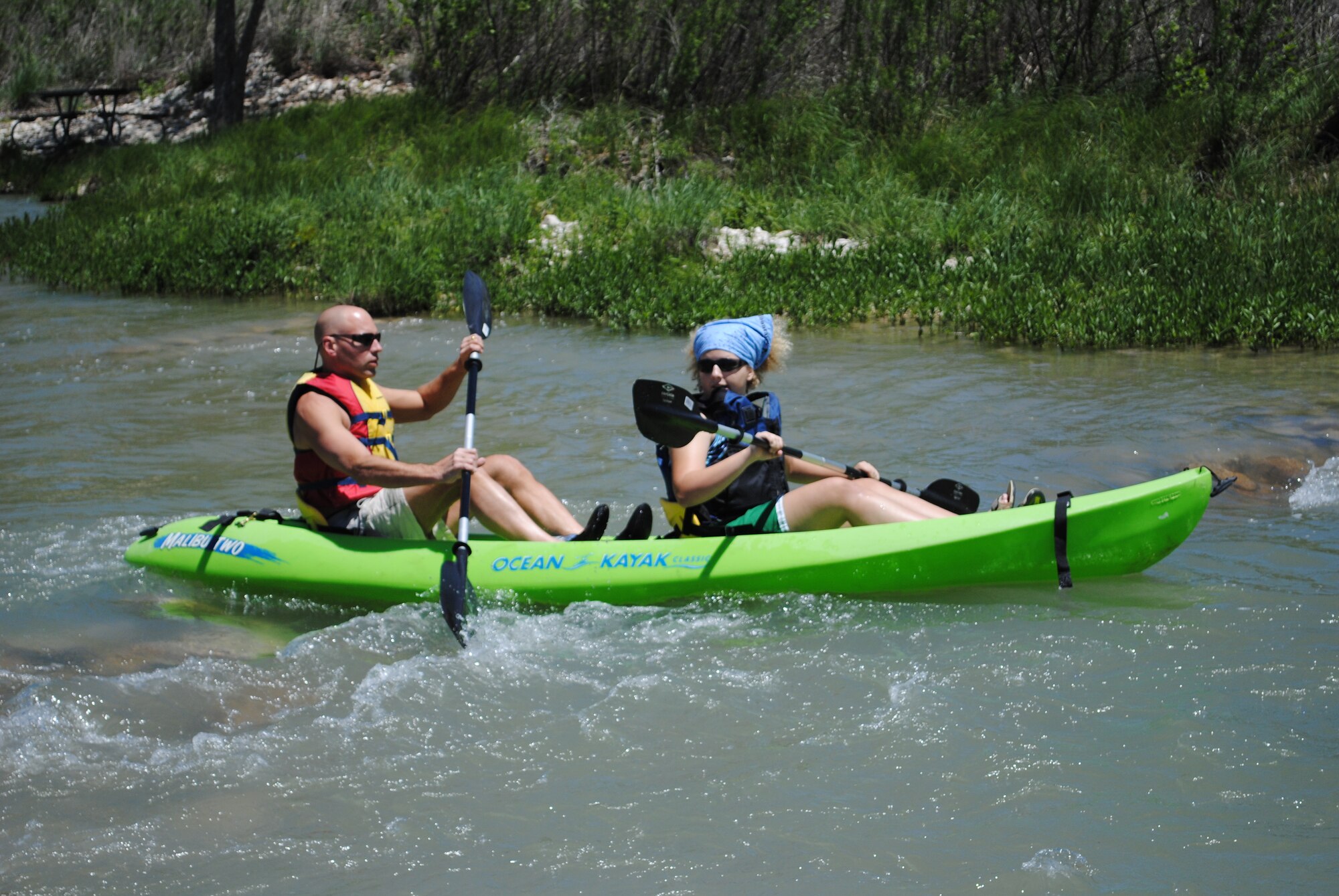 Martin Wirtz, 17th Force Support Squadron Outdoor Recreation, and his daughter Emma, enjoy kayaking down the Llano River during a camping and kayaking trip held by Outdoor Recreation April 24-25. Outdoor Recreation has plenty of trips scheduled for the spring and summer. They can also help plan individual trips; just call 325-654-3254. (U.S. Air Force photo/Kelley Kazura)