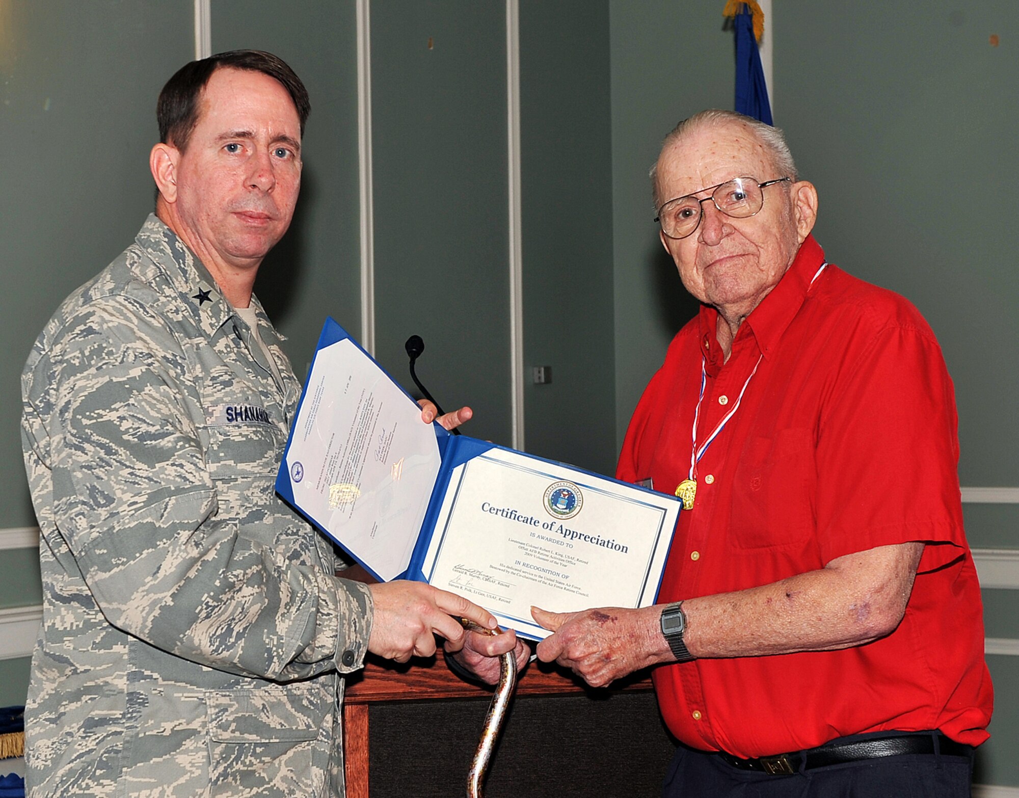 OFFUTT AIR FORCE BASE, Neb. -- Brig. Gen. John N.T. Shanahan, 55th Wing commander, presents the Retiree Activities Office Volunteer of the Year Award to retired Lt. Col. Robert L. King, volunteer deputy director of Offutt's RAO, during the Volunteer Appreciation Reception at the Patriot Club here April 28. More than 80 people from various organizations on and off-base attended the event to honor the contributions of Offutt's many volunteers. Colonel King contributed more than 280 hours in 2009 supporting the RAO. U.S. Air Force photo by Charles Haymond 