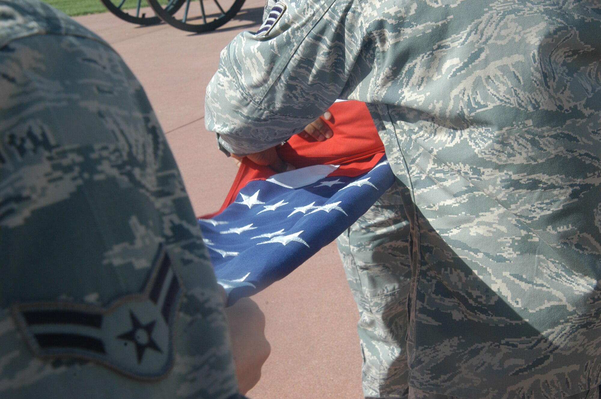 OFFUTT AIR FORCE BASE, Neb. -- Staff Sgt. Julius McCray, Airman 1st Class Darius T. Dinkins and Airman 1st Class Dylan Brown, all with the 55th Comptroller Squadron, carefully fold the American flag at the parade grounds here during a retreat ceremony April 29. The ceremony signifies the end of the duty day. U.S. Air Force photo by Staff Sgt. James M. Hodgman