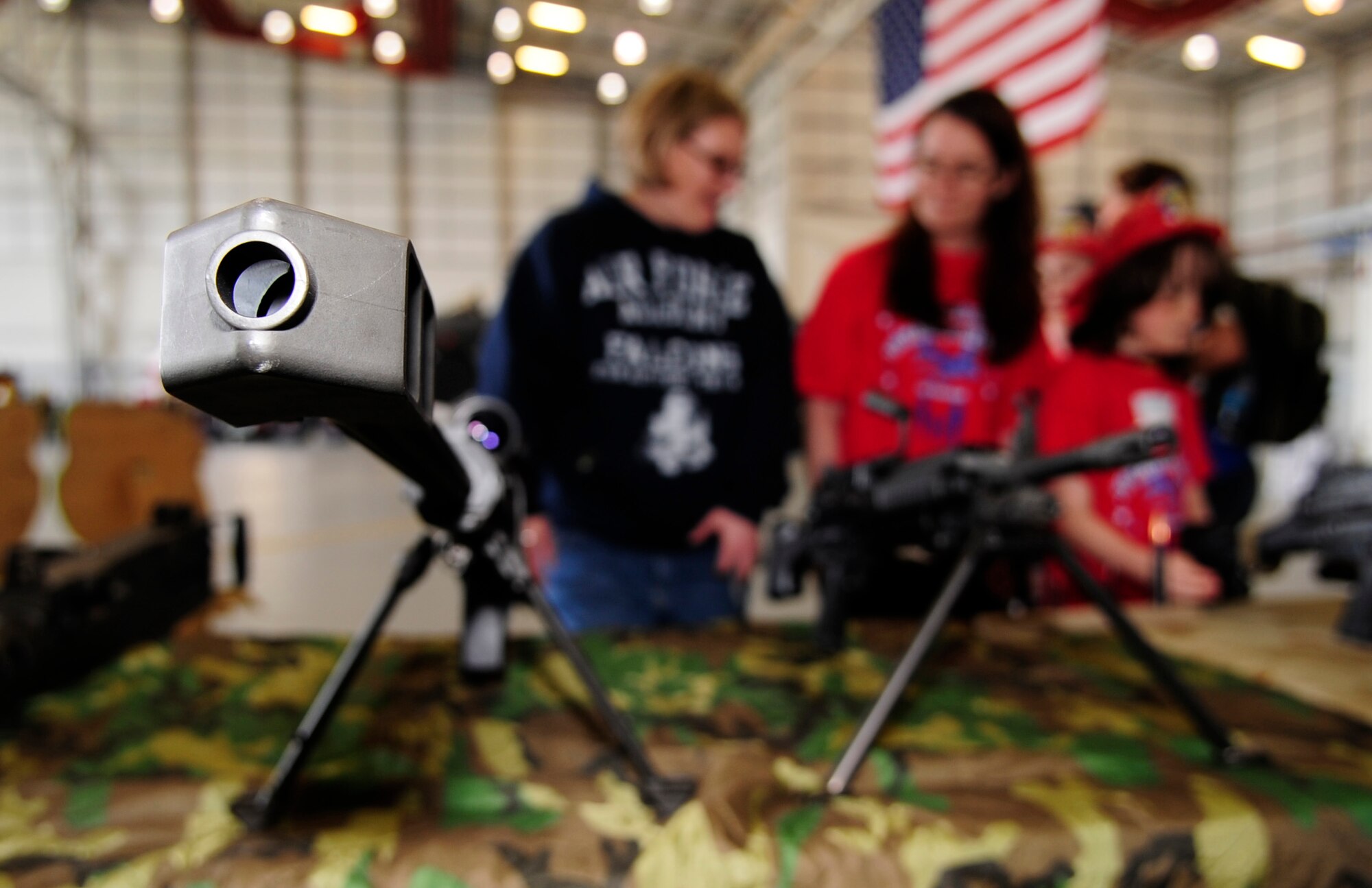 RAF MILDENHALL, England – Military members and their children view a weapons display during Operation Together and Ready May 1.  The event brought children through a mock-deployment line as well as several other static displays.  (U.S. Air Force photo/Staff Sgt. Christopher L. Ingersoll)