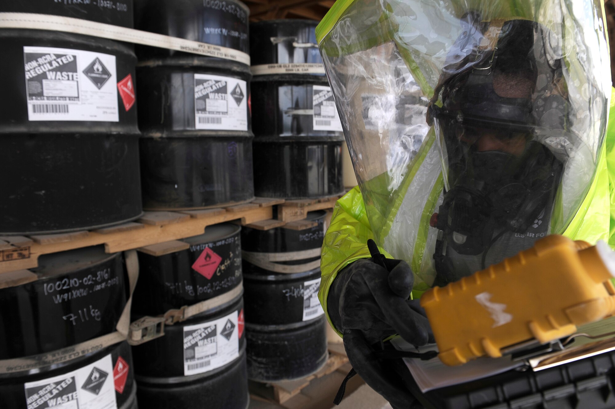 U.S. Air Force Staff Sgt. Alicia Lagarde, 455th Expeditionary Civil Engineer Squadron, examines chemical spill location during a hazardous materials exercise at Bagram Airfield, Afghanistan, April 29, 2010. Sergeant Lagarde are deployed from the Minnesota National Guard, is from Wrenshall, Minn. (U.S. Air Force photo by/ Master Sgt. Jeromy K. Cross/released)