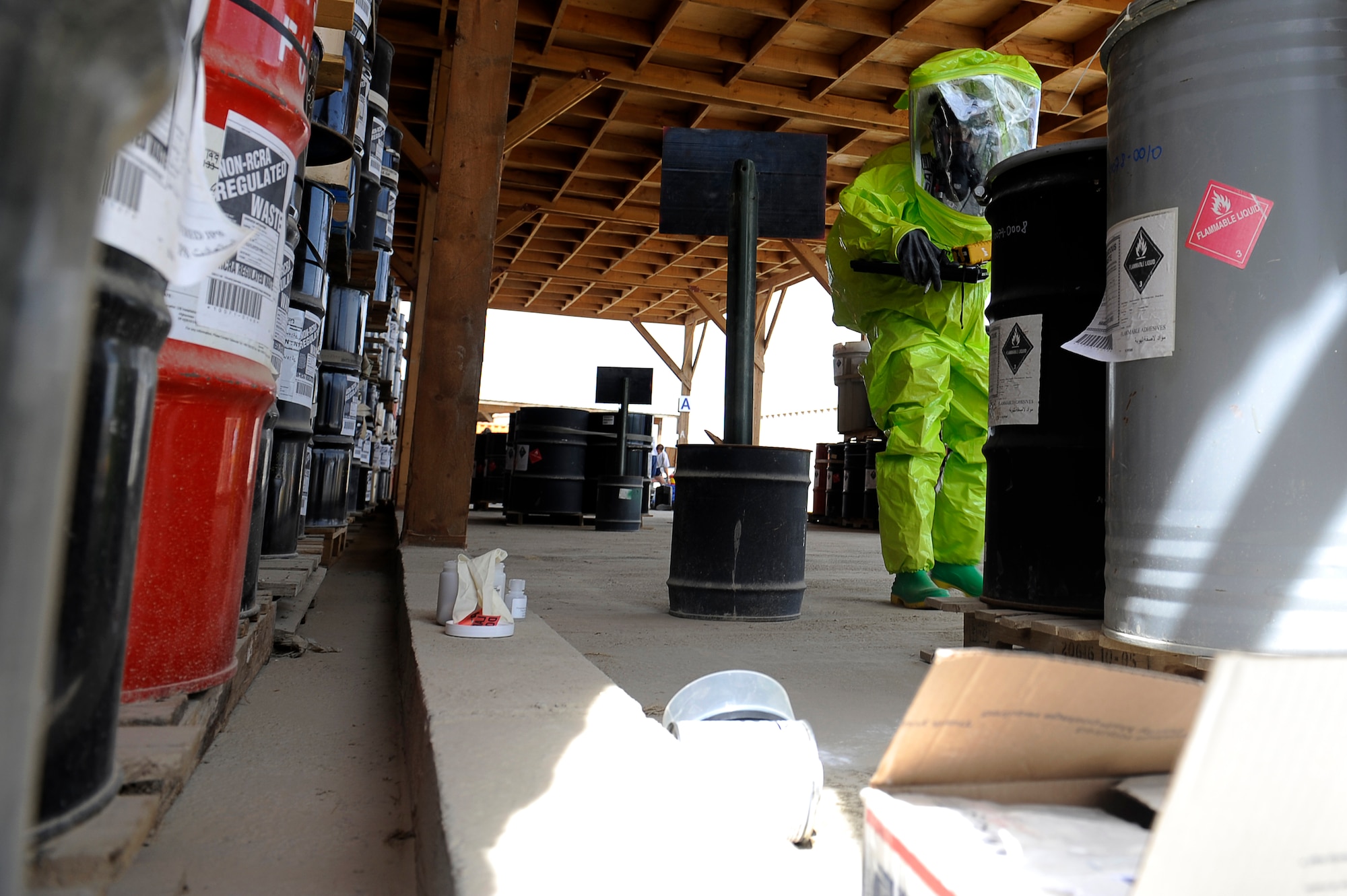 U.S. Air Force Staff Sgt. Alicia Lagarde, 455th Expeditionary Civil Engineer Squadron, examines chemical spill location during a hazardous materials exercise at Bagram Airfield, Afghanistan, April 29, 2010. Sergeant Lagarde are deployed from the Minnesota National Guard, is from Wrenshall, Minn. (U.S. Air Force photo by/ Master Sgt. Jeromy K. Cross/released)