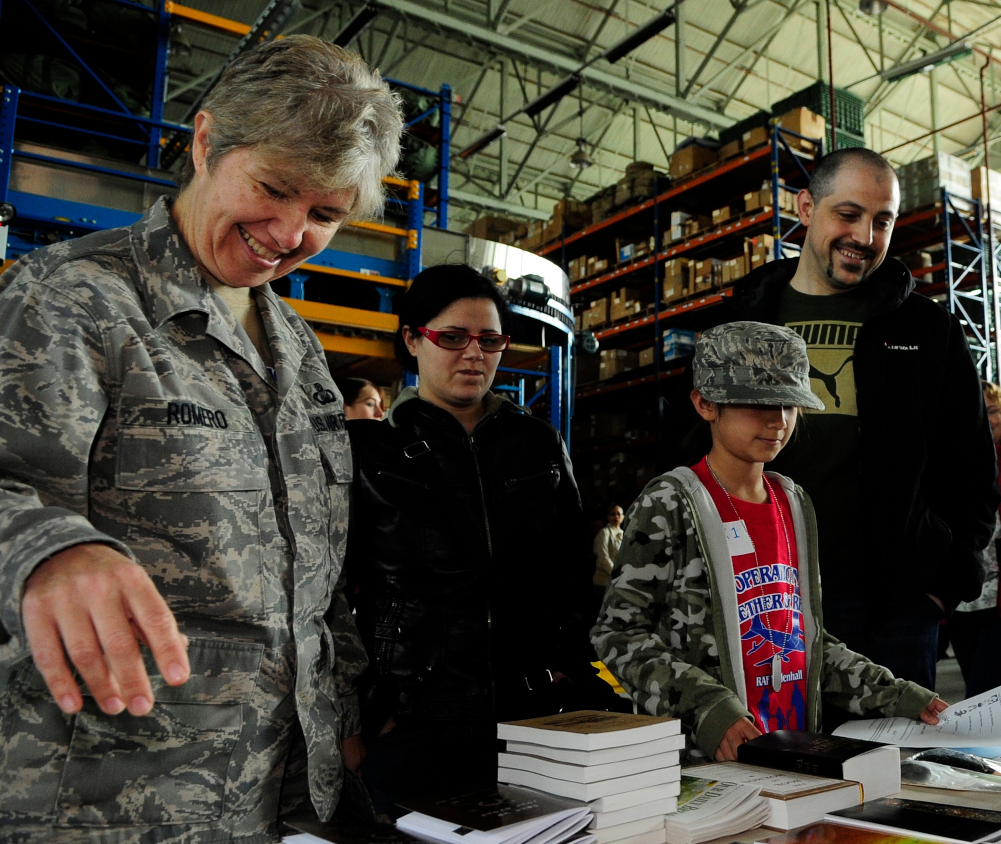 RAF MILDENHALL, England – Master Sgt. Kathleen Romero, 100th Air Refueling Wing, takes her daughter Elizabeth through a mock pre-deployment line May 1, while Francesco Ligorio and his niece Thommasina look on.  The event was part of Operation Together and Ready, which included aircraft static displays, working dog demonstrations and Sparky the Fire Dog.  (U.S. Air Force photo/Staff Sgt. Christopher L. Ingersoll)