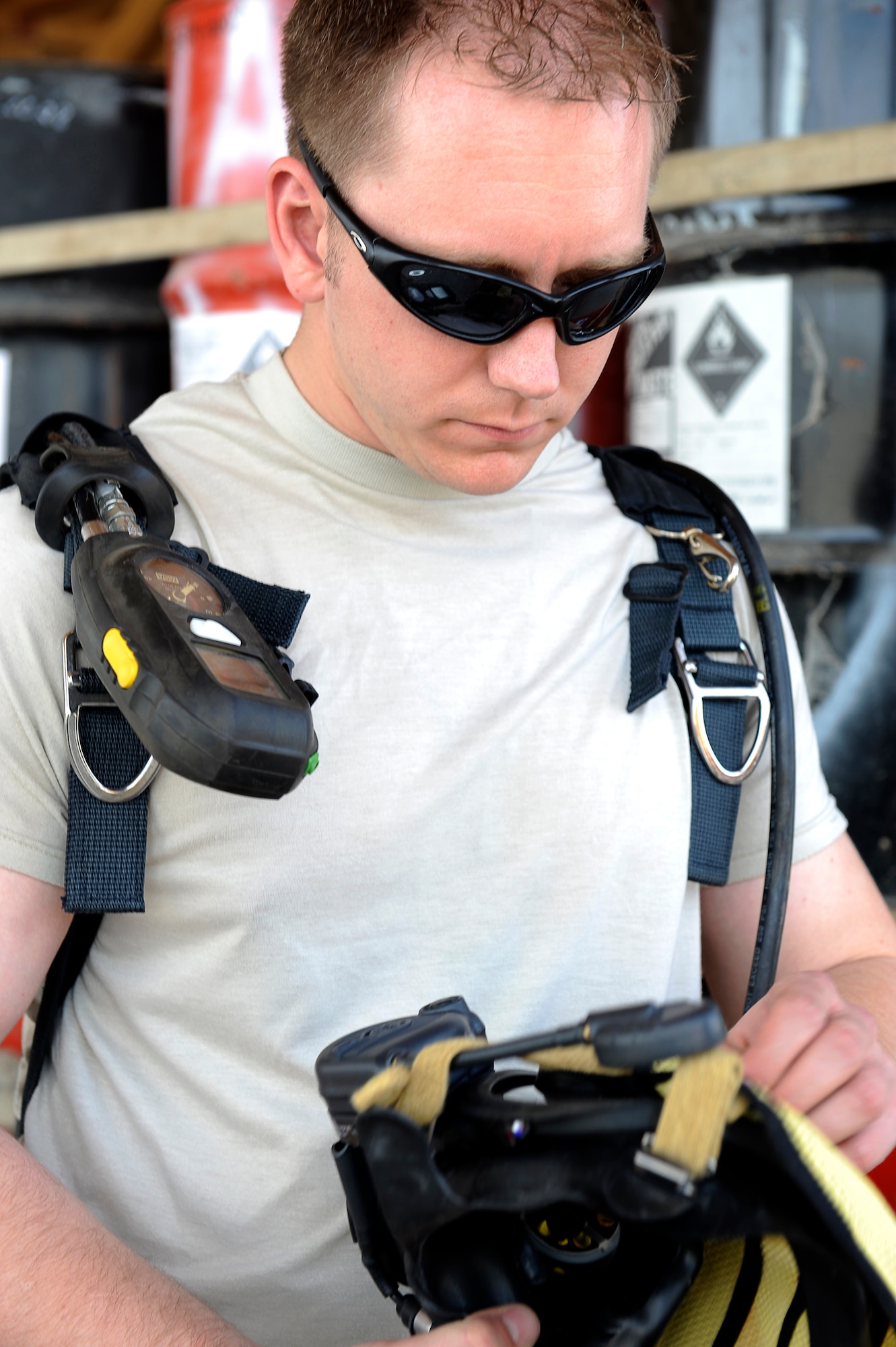 U.S. Air Force Senior Airman Michael Gilbert, 455th Expeditionary Medical Operations Squadron, inspects his mask during a hazardous materials exercise at Bagram Airfield, Afghanistan, April 29, 2010. Airman Gilbert is deployed from Nellis Air Force Base, Nev., and is from Exeter, Calif. (U.S. Air Force photo by/ Master Sgt. Jeromy K. Cross/released)